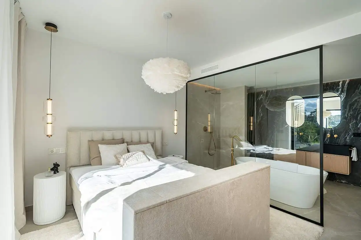 Spacious bedroom in a fully refurbished Marbella townhouse with elegant decor and natural light.