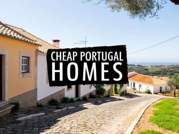 Traditional Portuguese village street with colorful houses and scenic landscape.