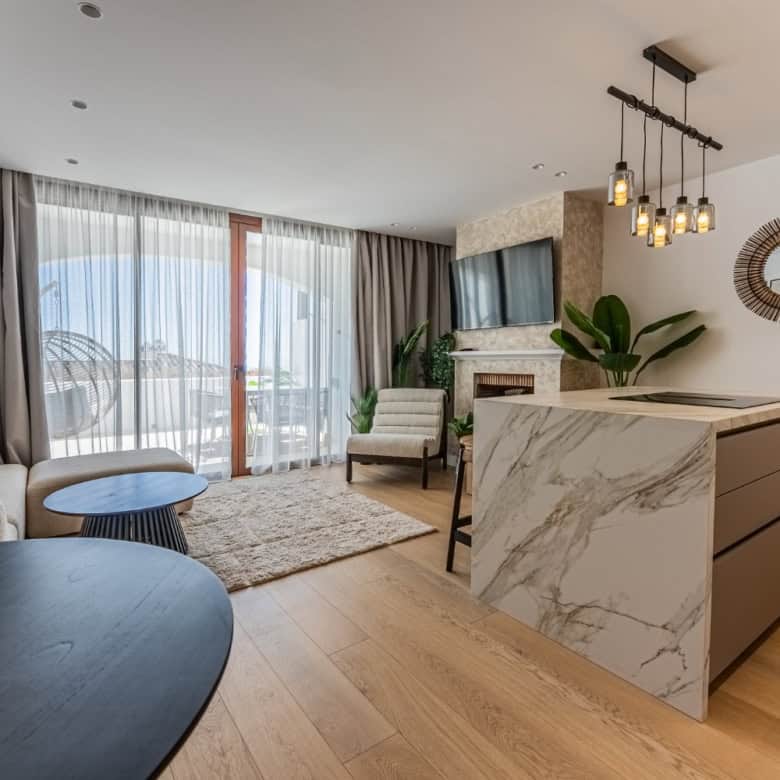 Spacious living area with contemporary decor, large windows, and stylish furnishings.