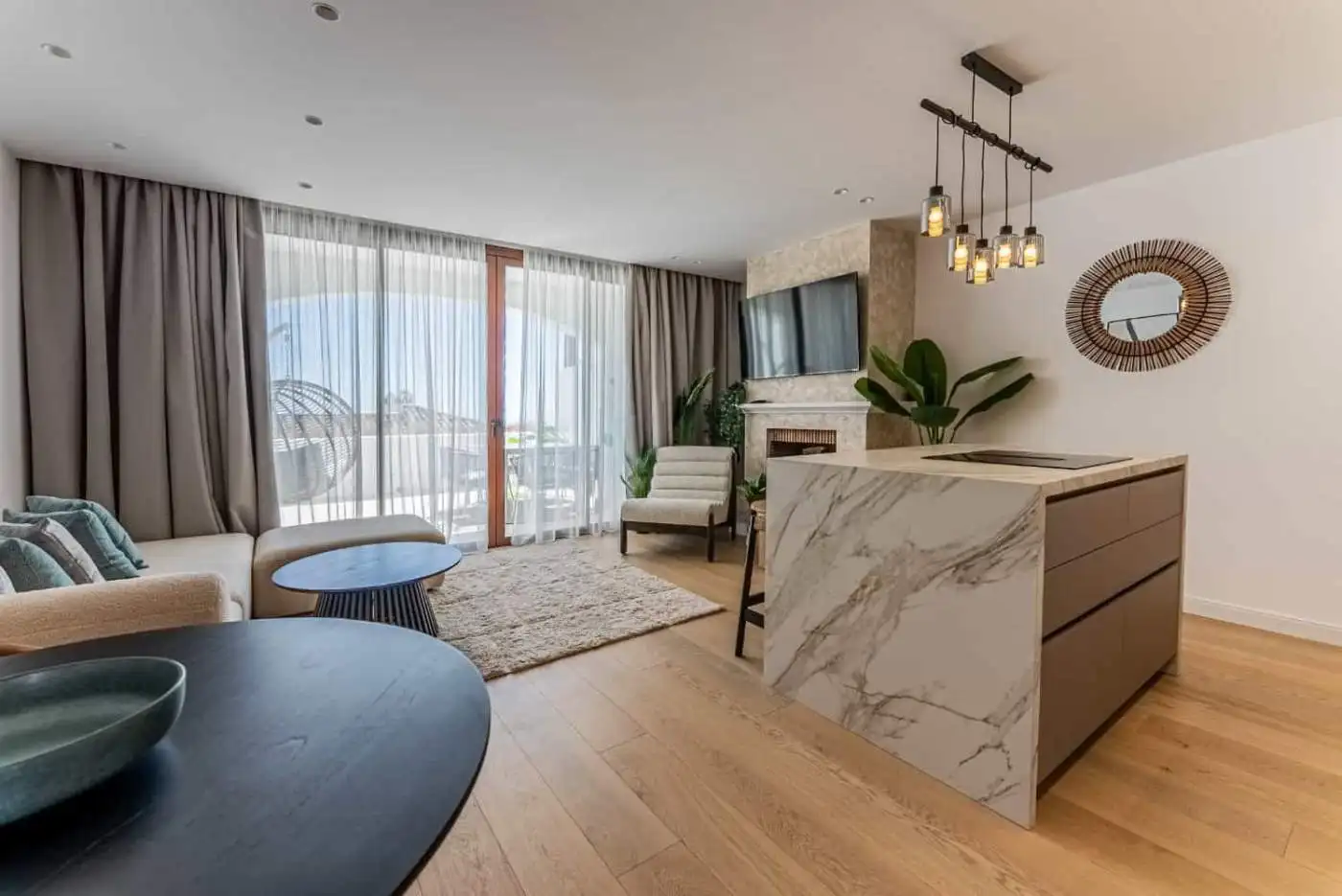 Spacious living area with contemporary decor, large windows, and stylish furnishings.
