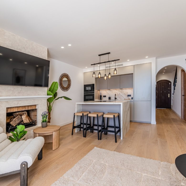Spacious living room with contemporary decor, flat-screen TV, and natural light in Los Arqueros Bena.