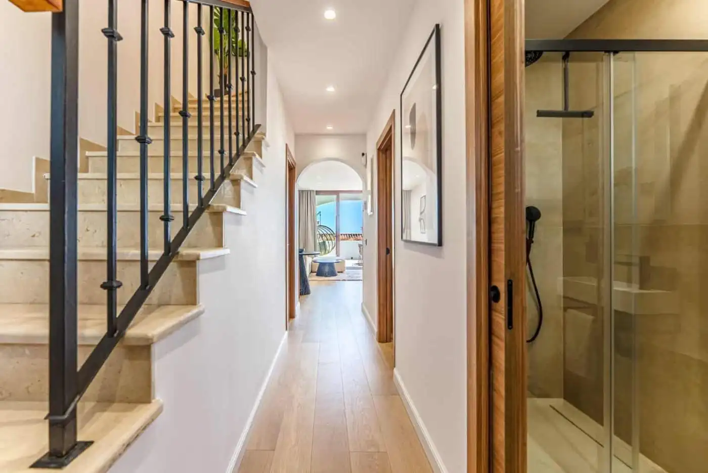 Modern townhouse hallway with staircase and shower area in Los Arqueros Benahavis.