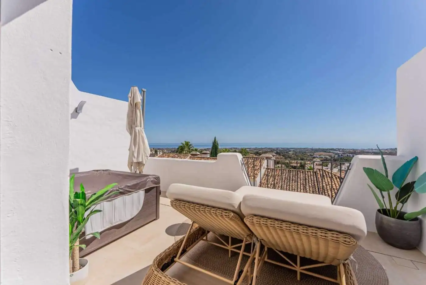 Modern terrace with sea views in Los Arqueros Benahavis, featuring comfortable outdoor furniture and.