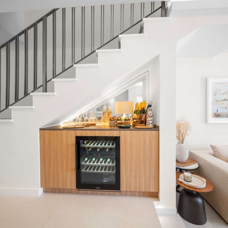 Modern townhouse interior with a wine fridge and cozy living area in El Palmeral, Nueva Andalucía.