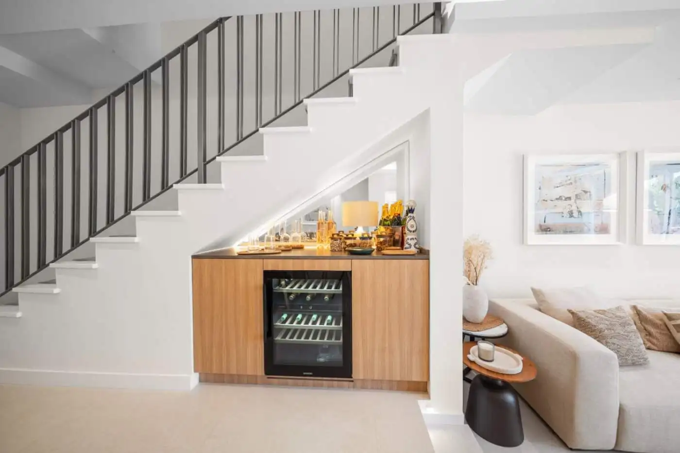 Modern townhouse interior with a wine fridge and cozy living area in El Palmeral, Nueva Andalucía.