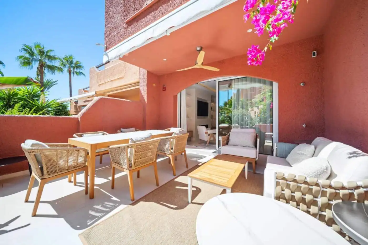 Elegant outdoor terrace with stylish furniture and vibrant flowers in El Palmeral, Nueva Andalucía.