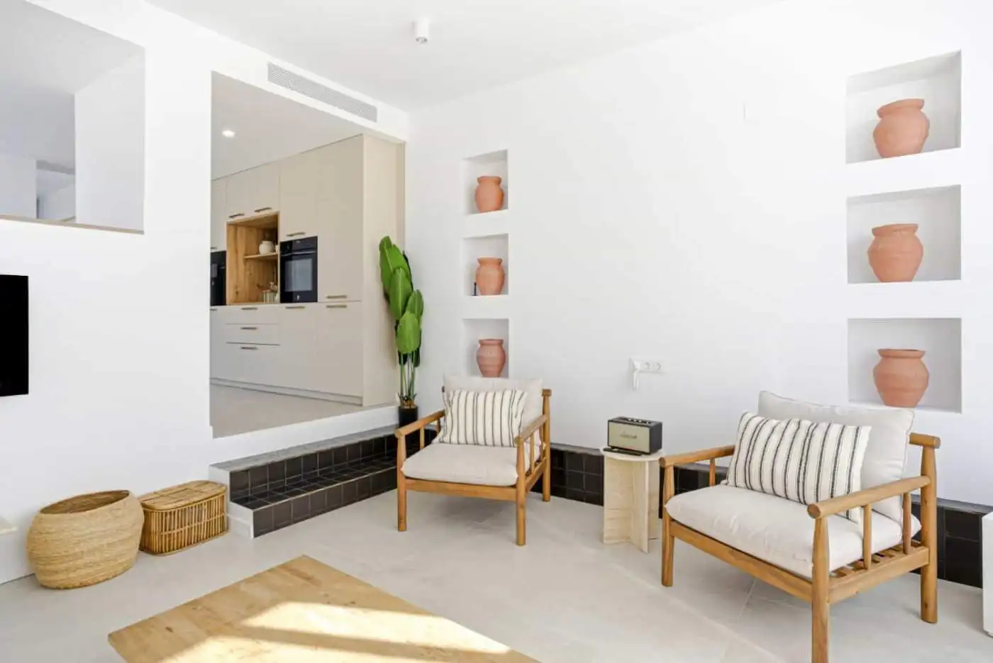 Bright and airy living room with minimalist decor in a corner townhouse in Cancelada, Estepona.