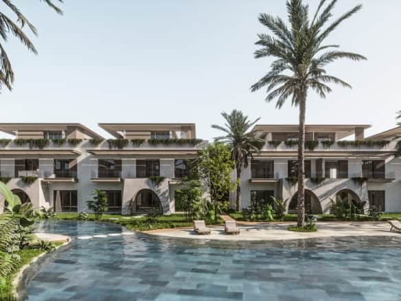 Modern beachfront villas with private pools and lush gardens in a tropical setting.