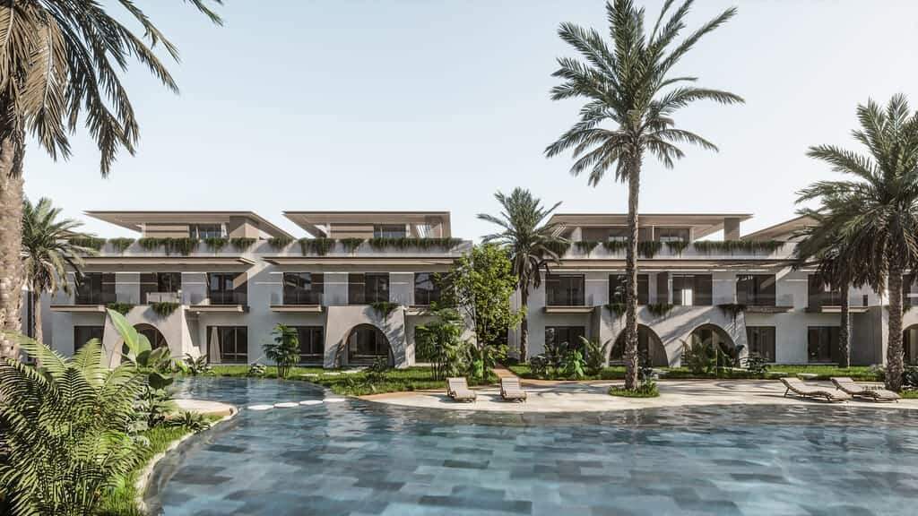 Modern beachfront villas with private pools and lush gardens in a tropical setting.