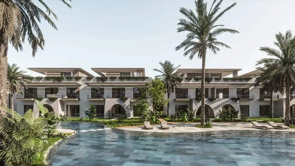 Modern beachfront villas with private pools and lush gardens in a tropical setting.