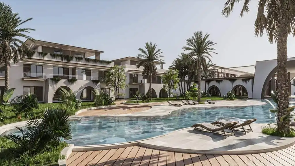 Luxury Caribbean resort pool with palm trees and modern architecture.