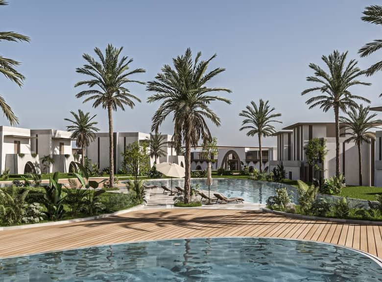 Modern luxury villa with swimming pool and lush palm trees in a tropical setting.