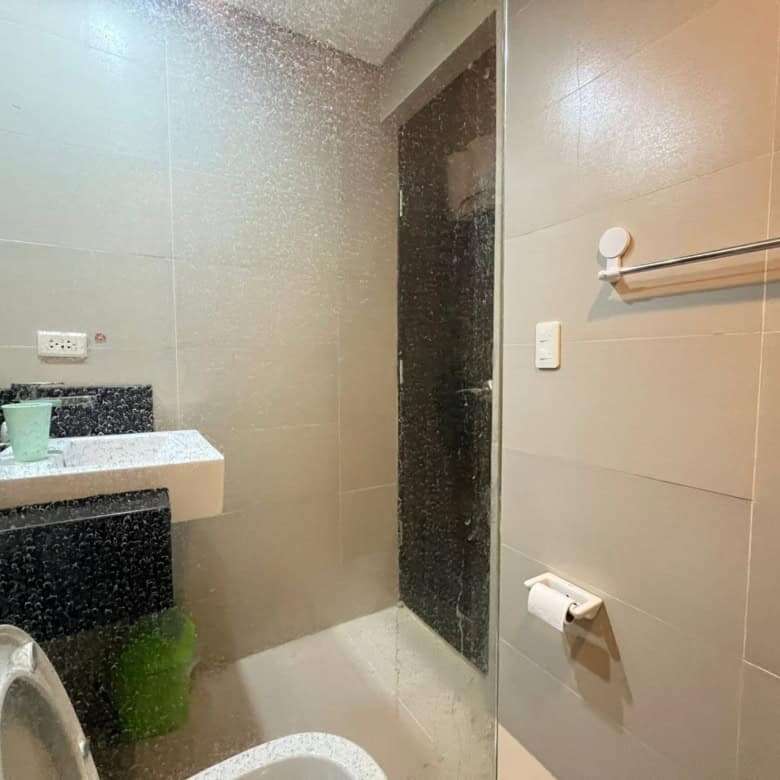 Bathroom with shower, sink, and toilet in Oceanway Residencies Boracay apartment.