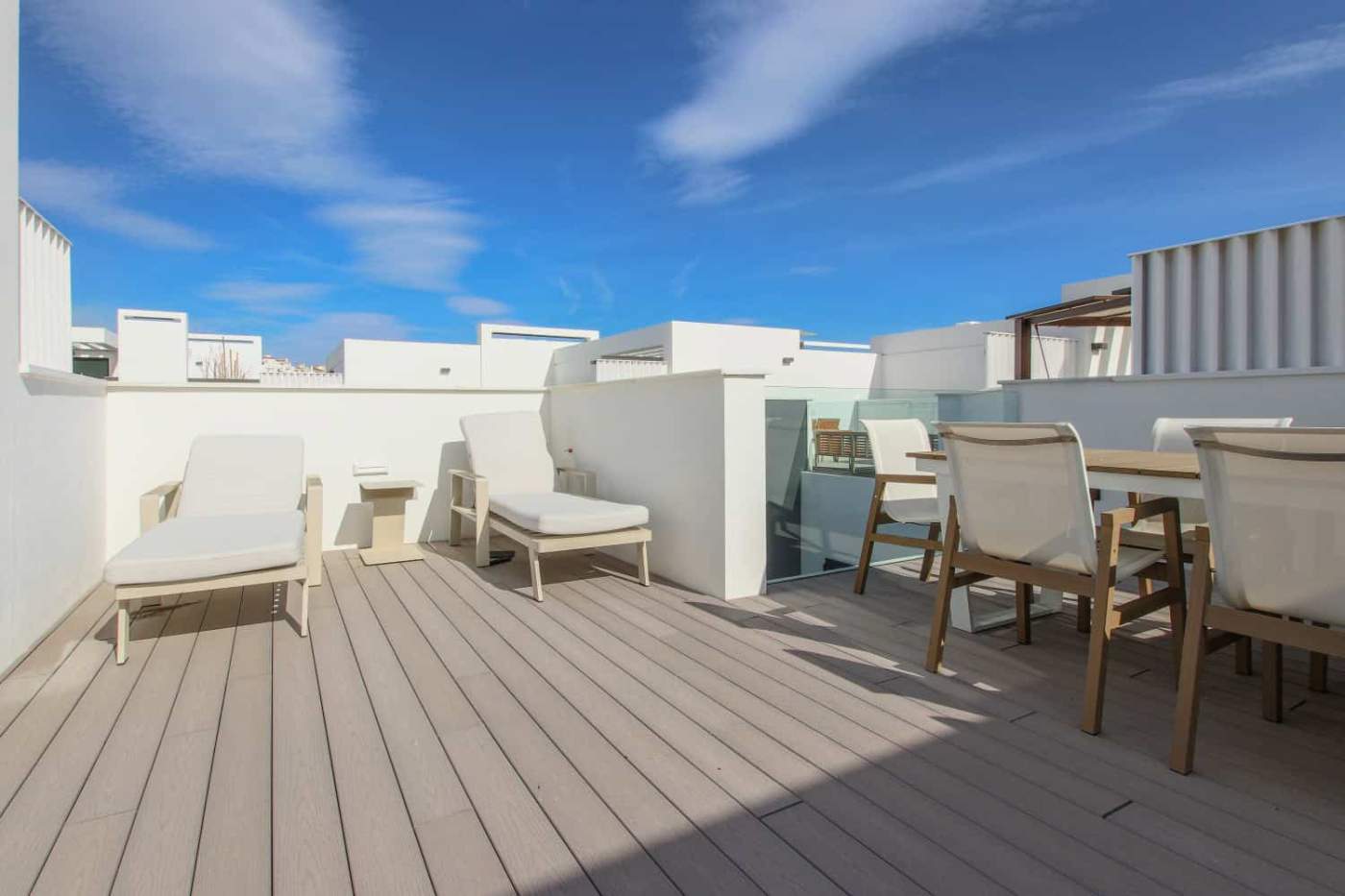 Beachfront terrace with lounge chairs and dining area in Estepona West.