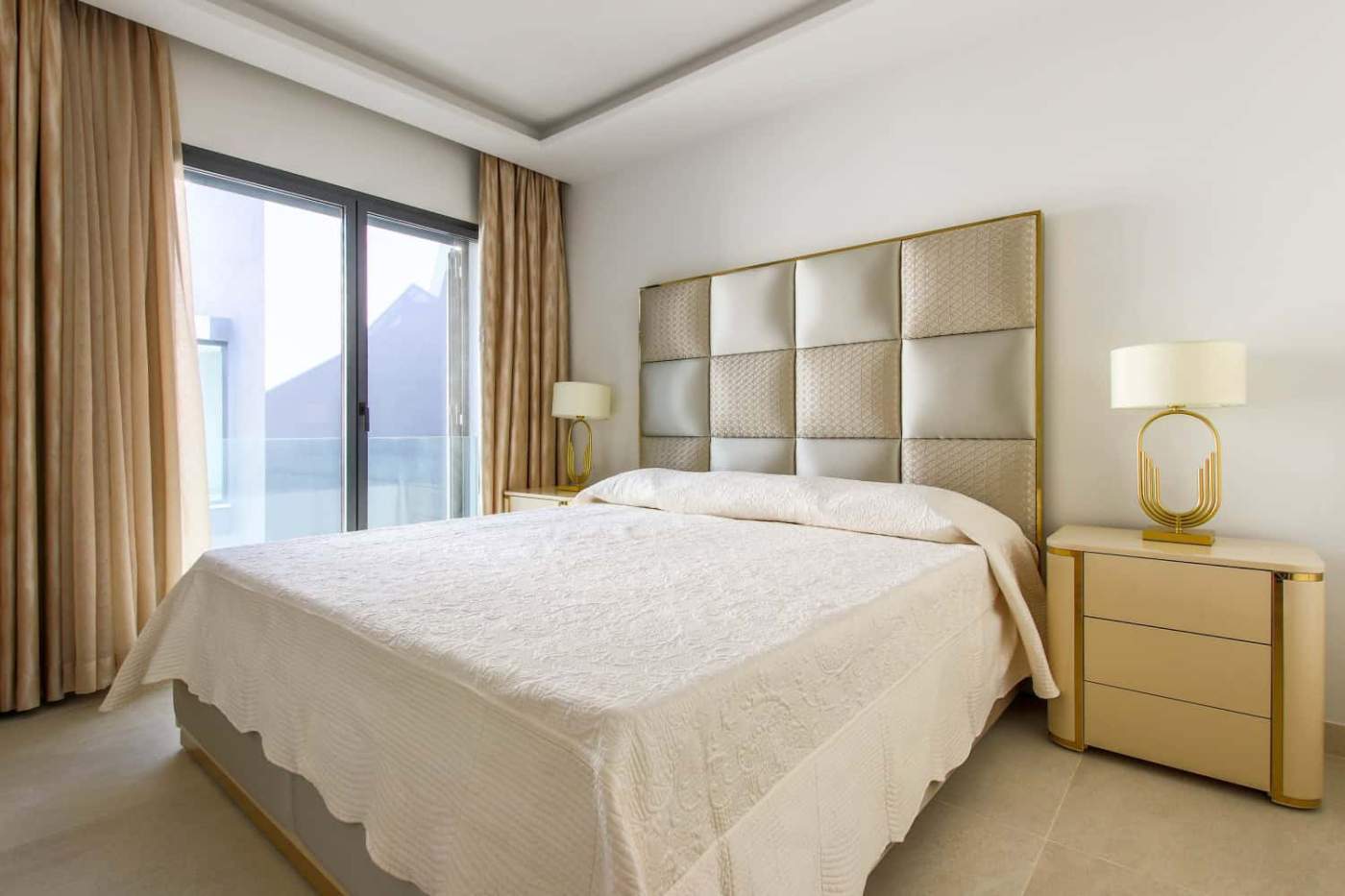 Beachfront bedroom with large window and elegant decor in Estepona West.