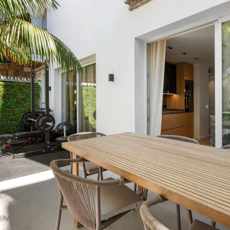 Stylish outdoor dining space of a luxury townhouse in Marbella's Golden Mile.