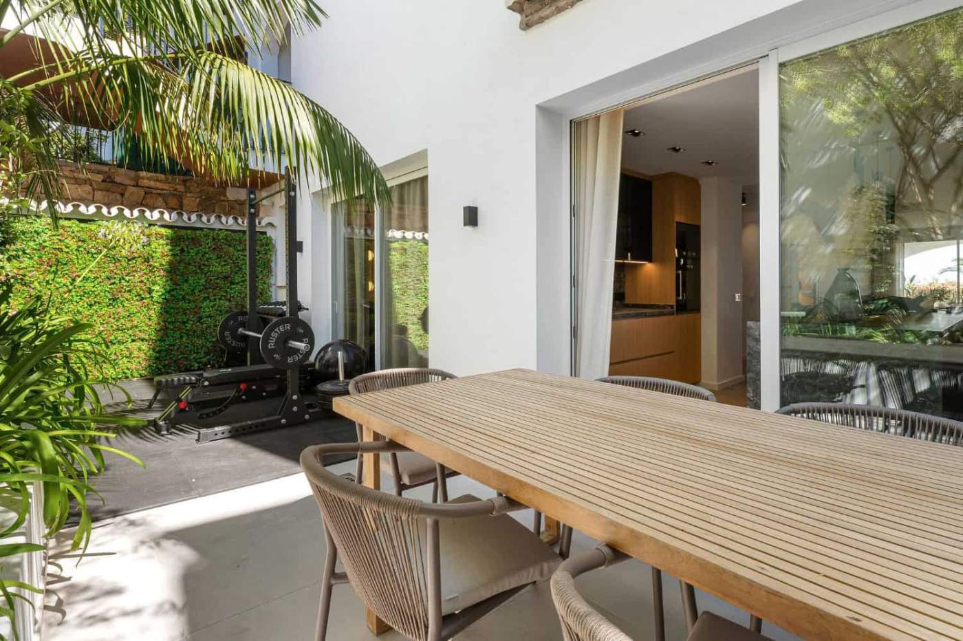 Modern Marbella townhouse outdoor dining area Stylish outdoor dining space of a luxury townhouse in Marbella's Golden Mile.
