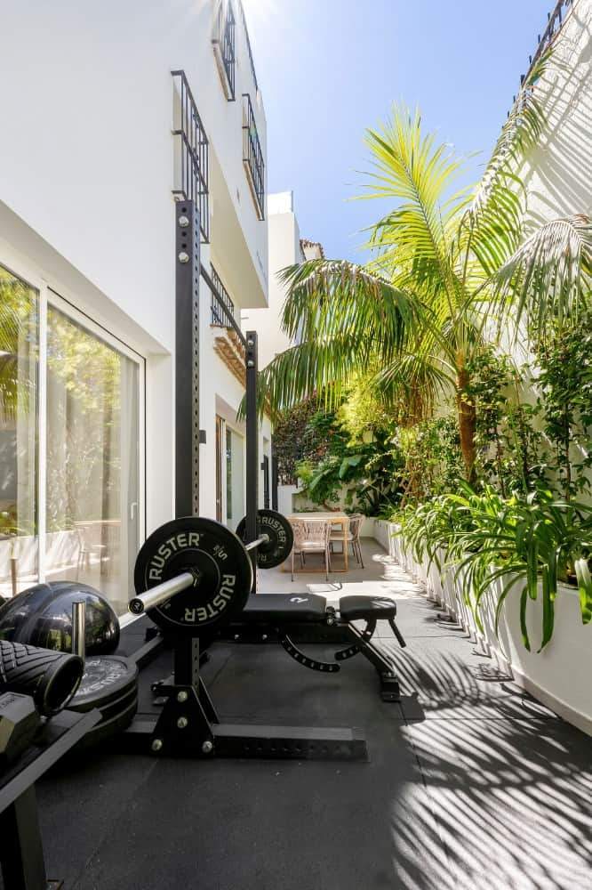 Luxury Townhouse in Club Sierra, Golden Mile Marbella Outdoor gym area with fitness equipment and lush greenery in Marbella.