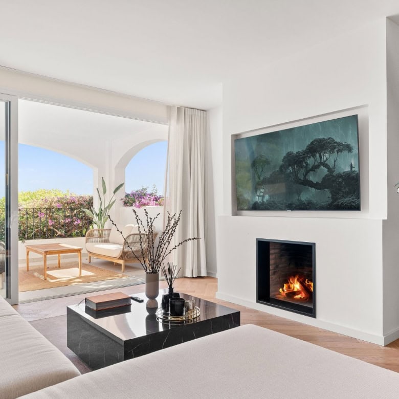 Luxury townhouse living room with modern fireplace and large balcony view.