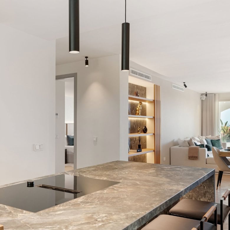 Modern townhouse kitchen and living area in Marbella's Golden Mile. Elegant design with open-plan la.