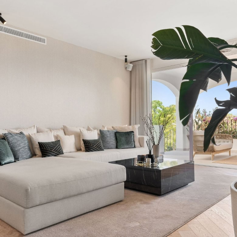 Elegant Marbella townhouse living room with modern decor and spacious seating area.