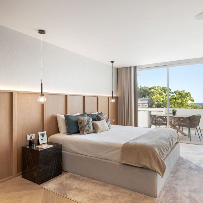 Luxury bedroom with modern decor and sea view in Marbella.