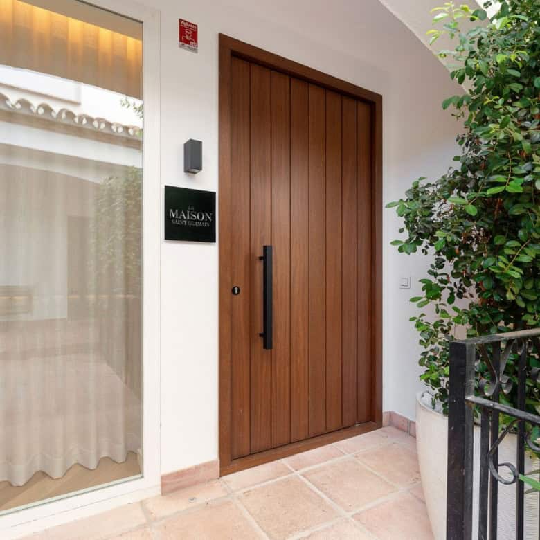 Entrance door of a luxury townhouse in Club Sierra, Golden Mile Marbella. Modern design with greener.