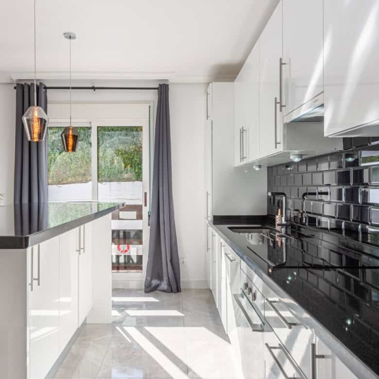 Spacious kitchen of a beautiful 3-bedroom corner apartment in La Maestranza, Nueva Andalucía, featur.