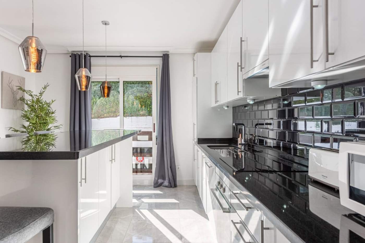 Spacious kitchen of a beautiful 3-bedroom corner apartment in La Maestranza, Nueva Andalucía, featur.