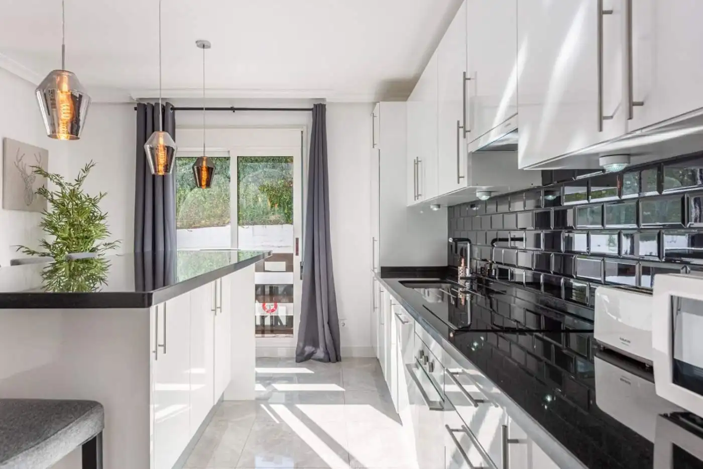 Spacious kitchen of a beautiful 3-bedroom corner apartment in La Maestranza, Nueva Andalucía, featur.