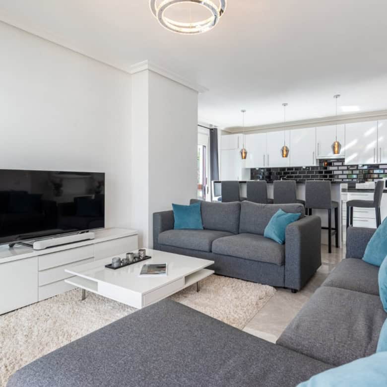 Spacious living room with contemporary furniture and a large flat-screen TV in La Maestranza, Nueva.