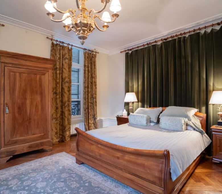 Elegant bedroom in a stunning 5-bed house in Chateaudun, France, featuring classic wooden furniture.