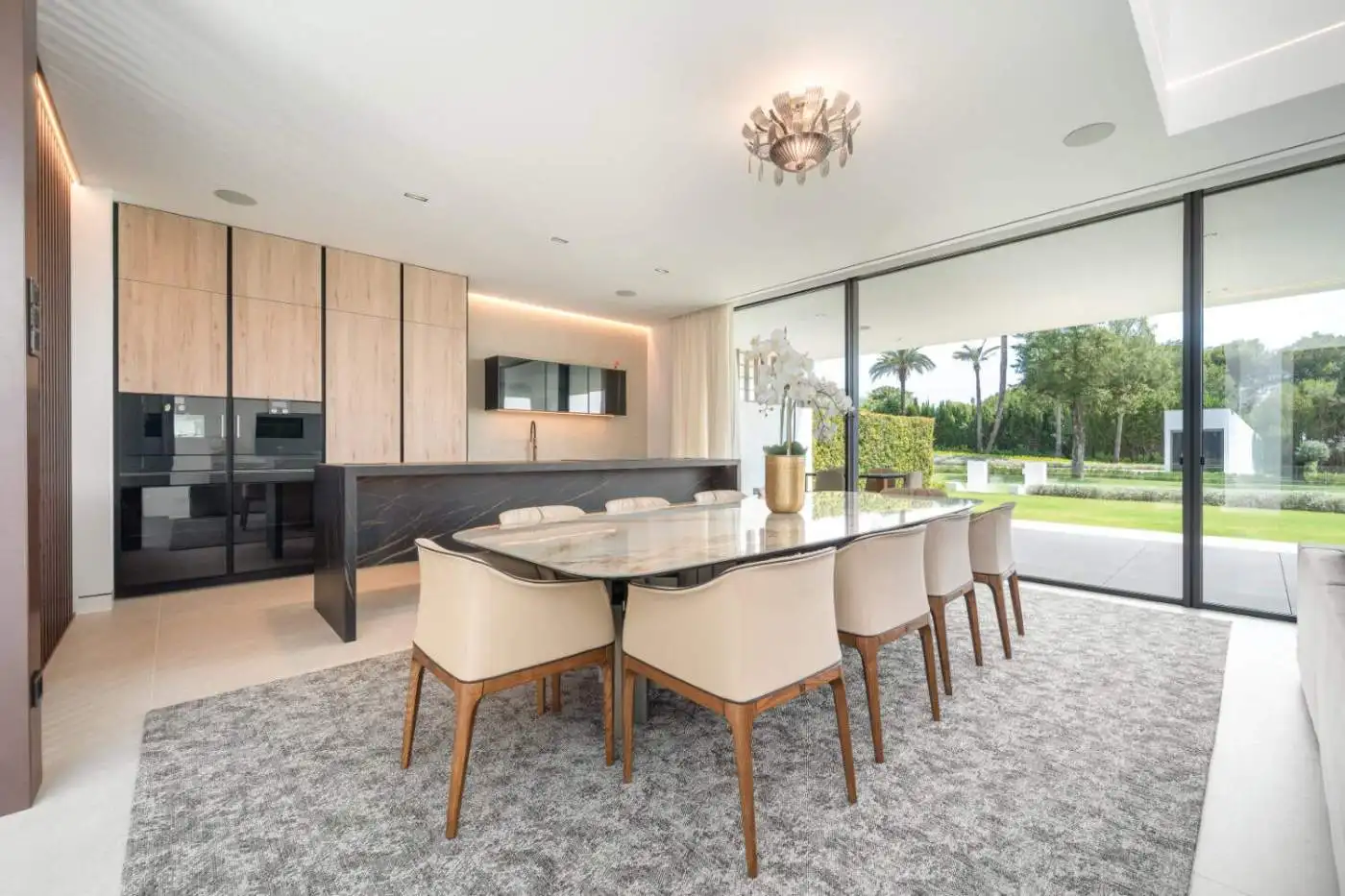 Elegant contemporary dining room with large windows and scenic views.