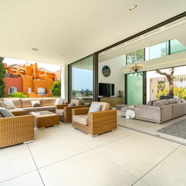 Luxurious modern villa featuring an open-plan living area with floor-to-ceiling windows and a stunni.