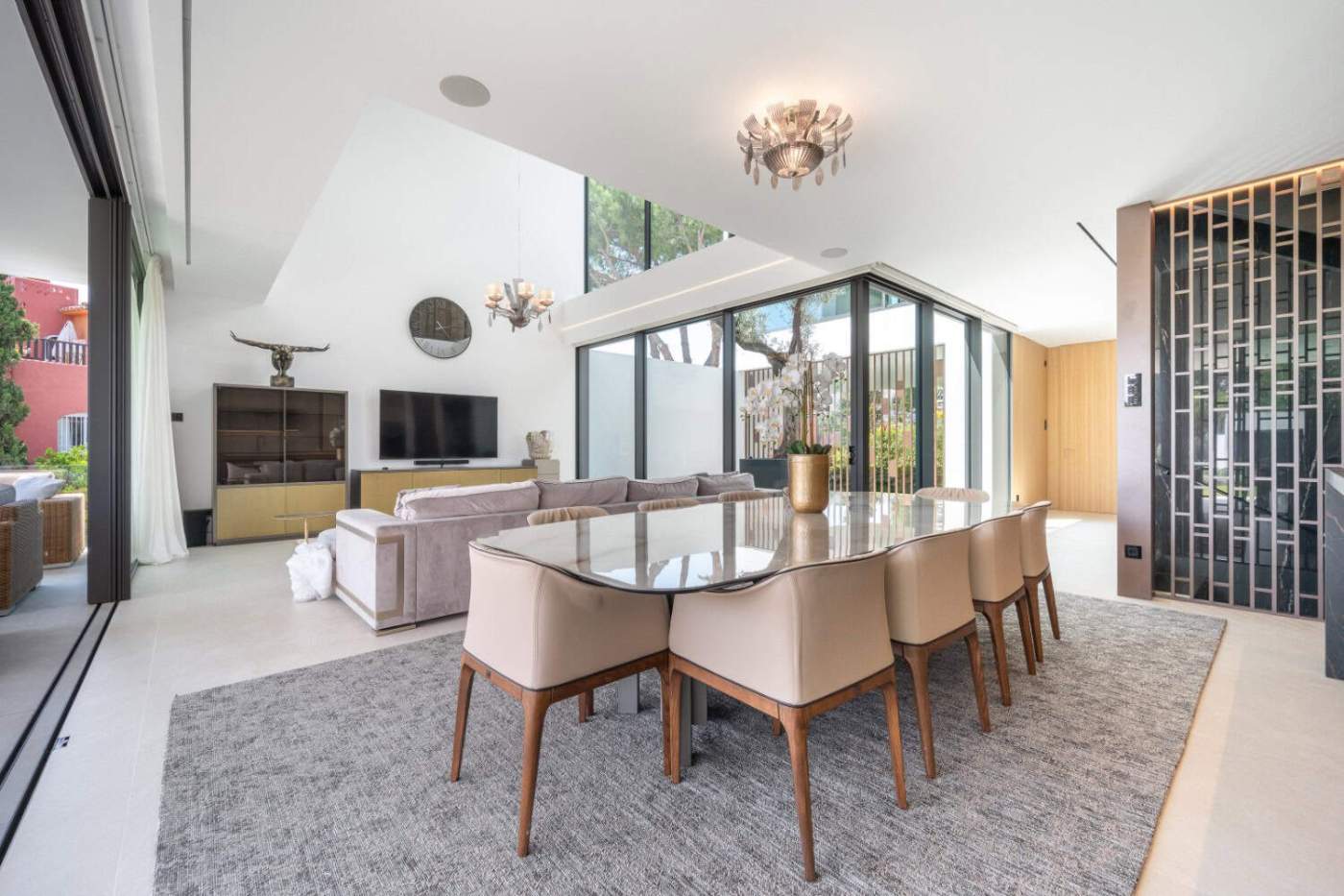 Contemporary Semi-Detached Villa with Rooftop Pool Modern villa interior with spacious dining and living area, large windows, and stylish decor.