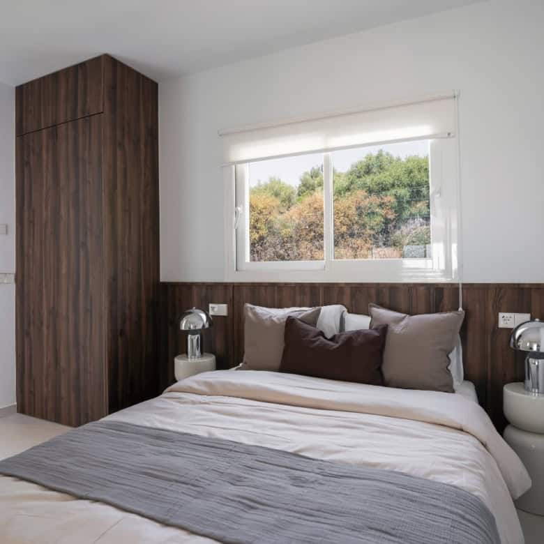 Stylish bedroom with contemporary decor in La Quinta Village duplex penthouse. Bright space with lar.