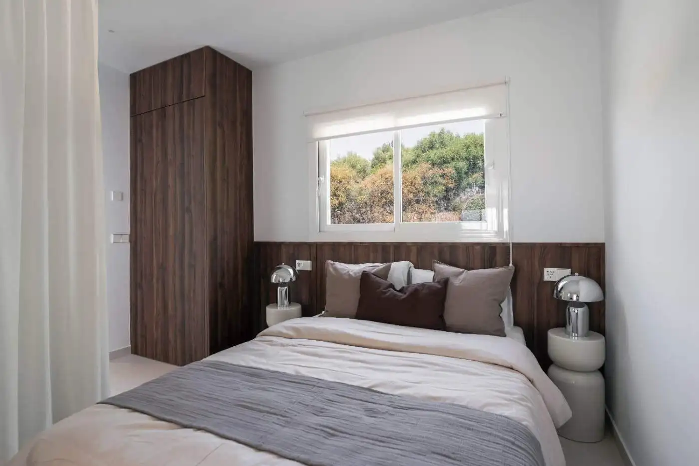 Stylish bedroom with contemporary decor in La Quinta Village duplex penthouse. Bright space with lar.