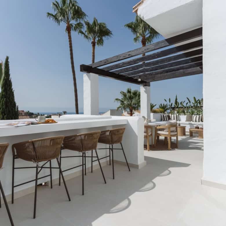 Elegant duplex penthouse terrace with outdoor seating and panoramic views.