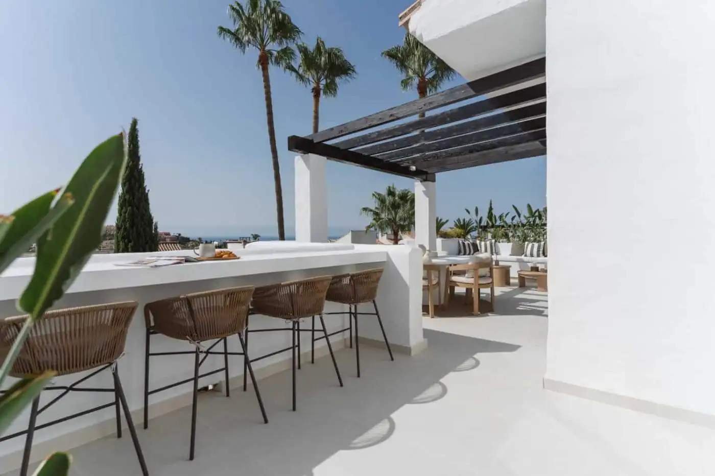 Elegant duplex penthouse terrace with outdoor seating and panoramic views.