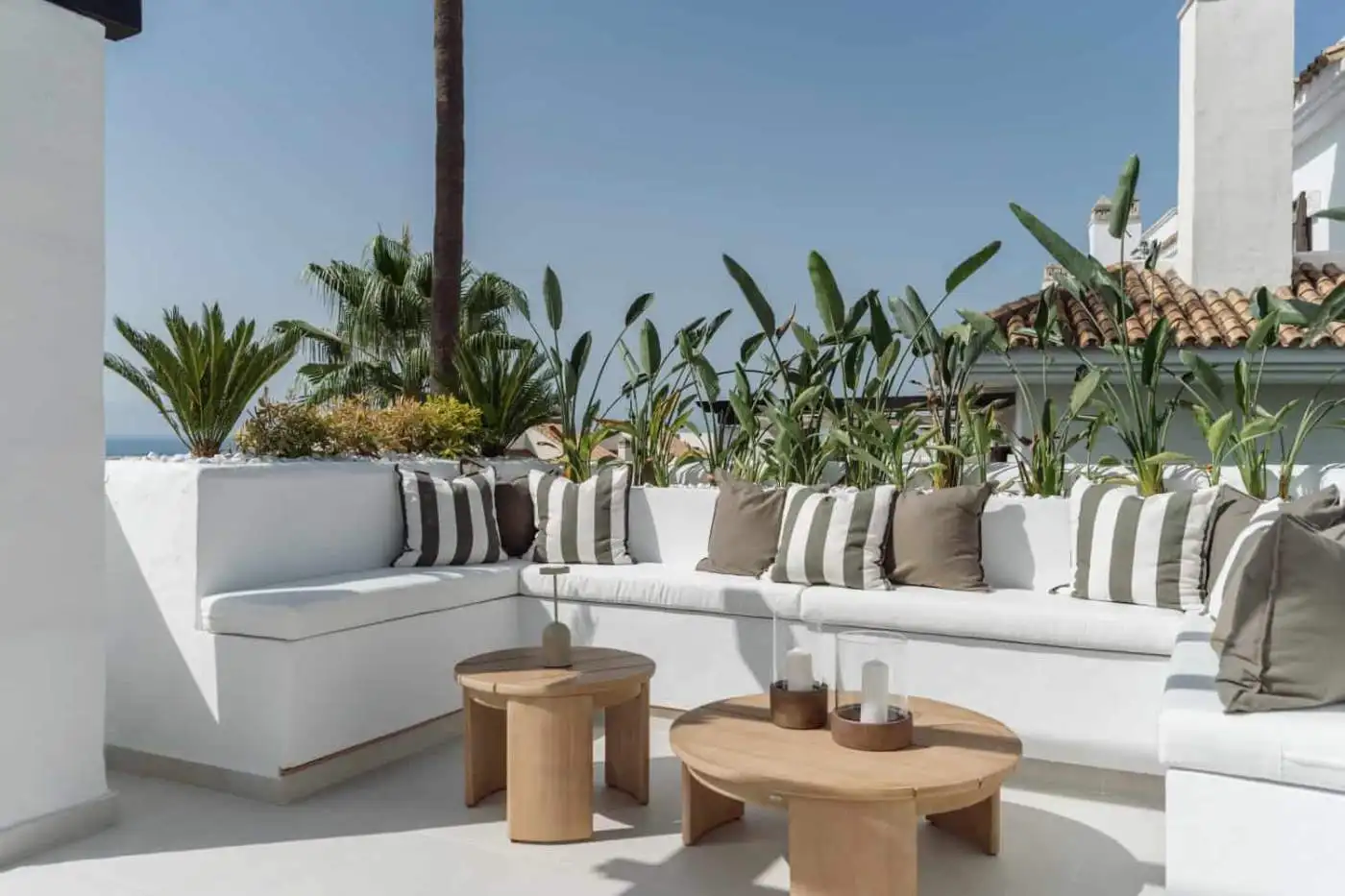 La Quinta Village corner duplex penthouse with outdoor seating and lush greenery.