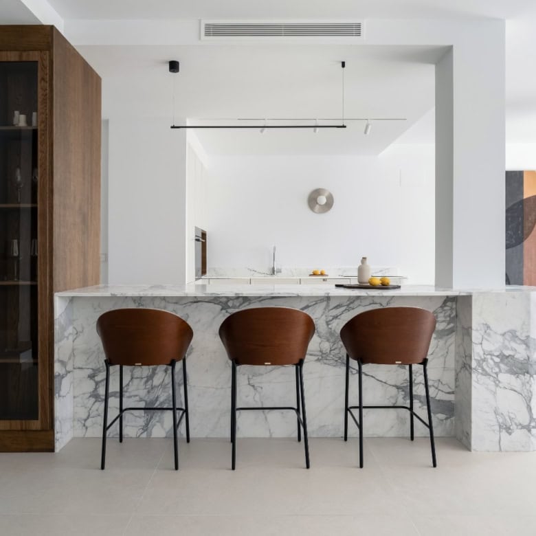Spacious kitchen in La Quinta Village Corner Duplex Penthouse featuring a marble island and contempo.
