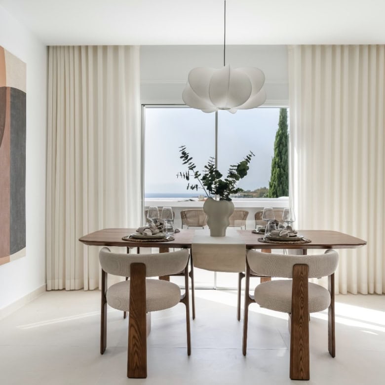 Elegant dining area with large window overlooking the sea in La Quinta Village Corner Duplex Penthou.