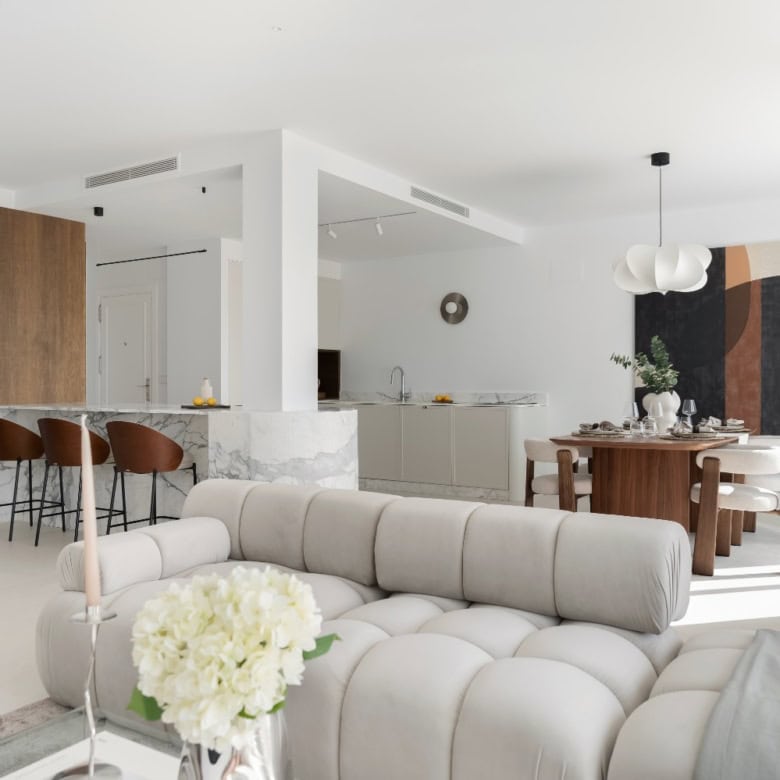 Bright, spacious duplex penthouse living area with modern decor and open-plan design.