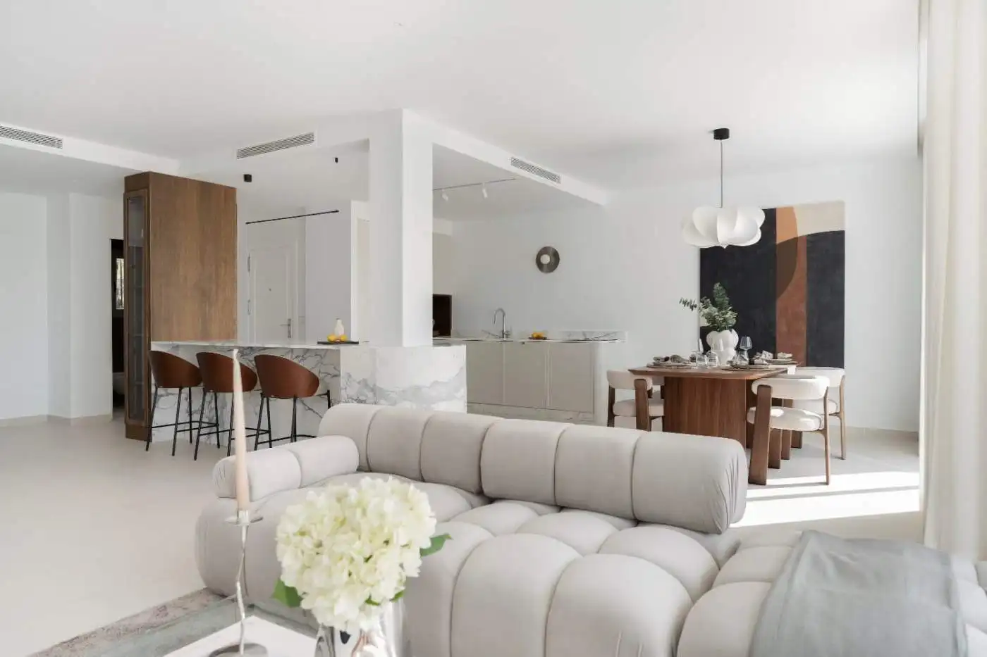 Bright, spacious duplex penthouse living area with modern decor and open-plan design.