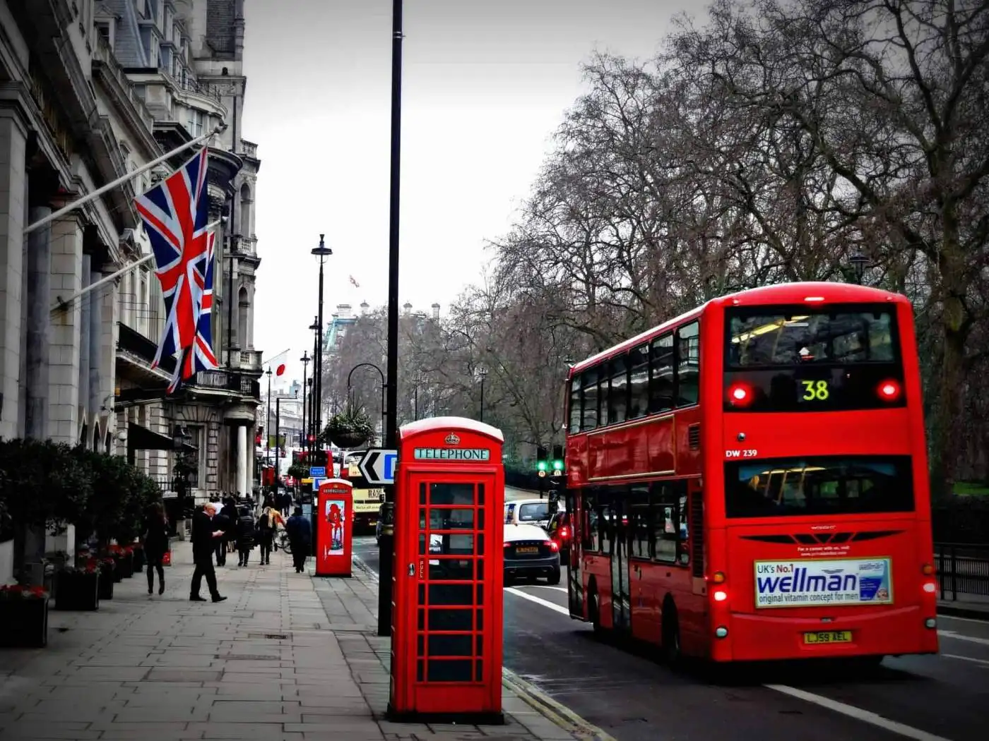 London street scene with red double-decker bus, phone booth, and Union Jack flag.