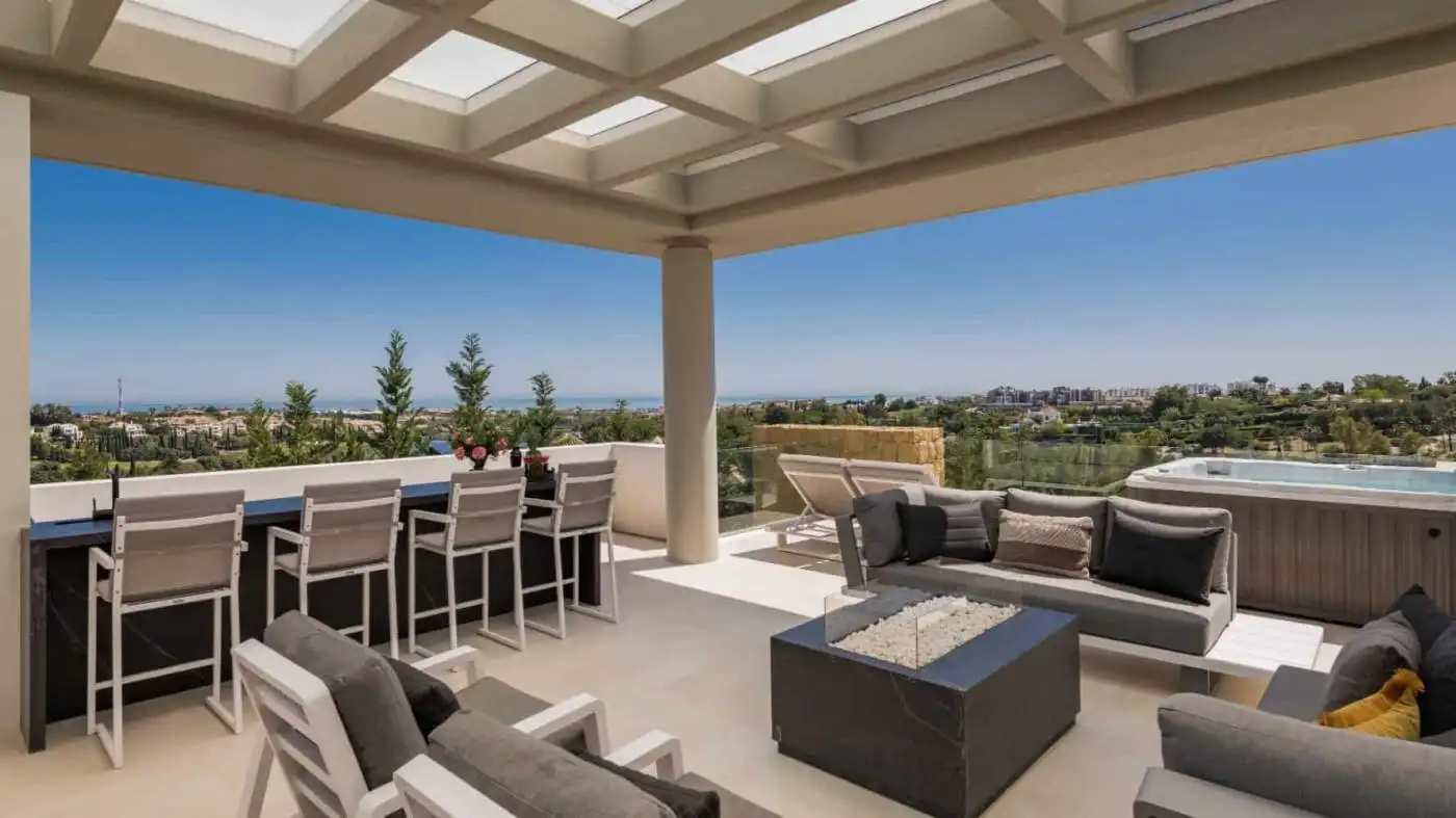 Modern villa terrace overlooking Los Flamingos with seating and panoramic city views.