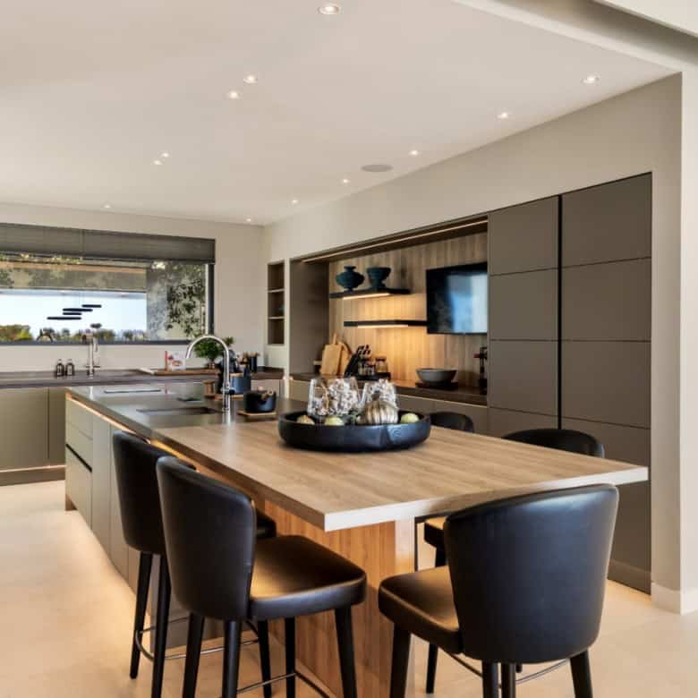 Luxurious modern villa interior with open-plan kitchen and stylish decor in Los Flamingos Resort.