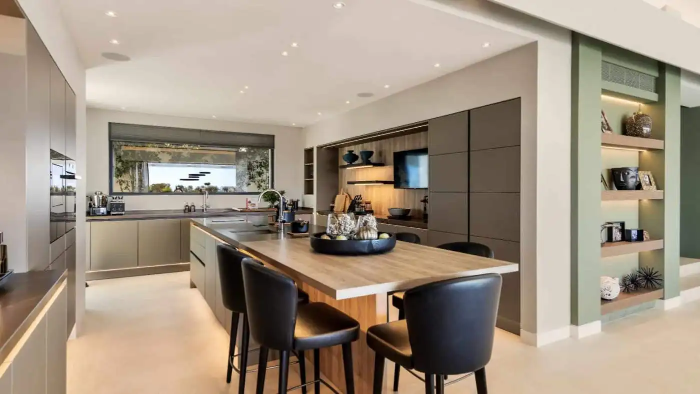 Luxurious modern villa interior with open-plan kitchen and stylish decor in Los Flamingos Resort.