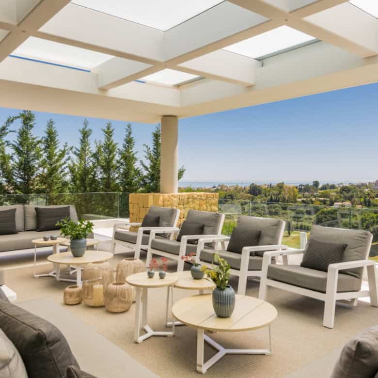 Elegant modern villa terrace with outdoor seating and panoramic views.