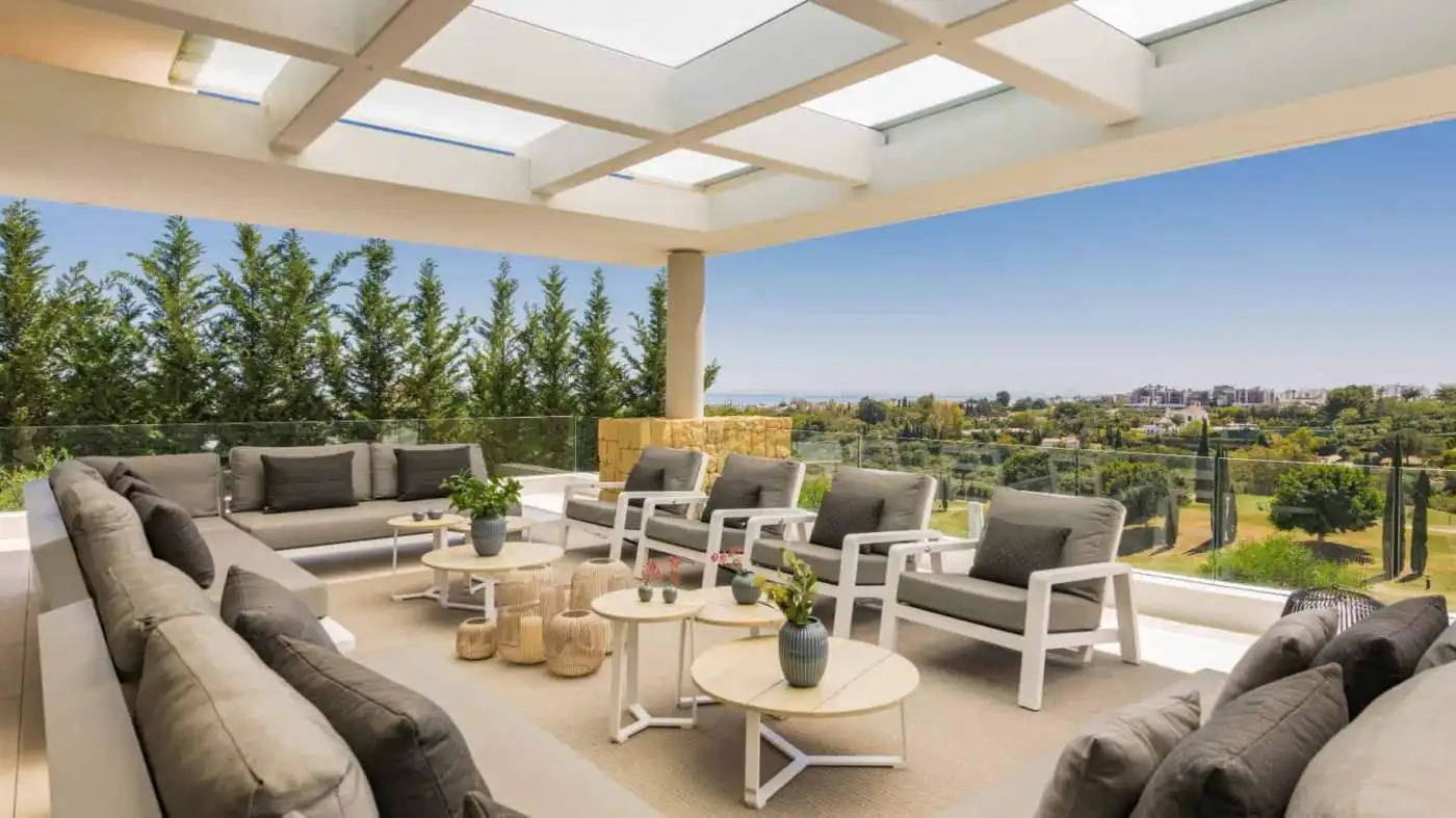 Elegant modern villa terrace with outdoor seating and panoramic views.